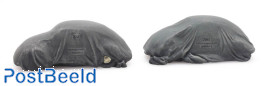 Two VW Beetles under tarpaulin